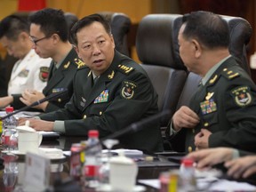 FILE - China's People's Liberation Army (PLA) Gen. Li Zuocheng, center, speaks during a meeting with U.S. Army Chief of Staff Gen. Mark Milley, not shown, at the Bayi Building in Beijing on Aug. 16, 2016. China has demanded the U.S. cease military "collusion" with Taiwan during a virtual meeting between the joint chiefs of staff from the two countries, whose relationship has grown increasingly fractious.