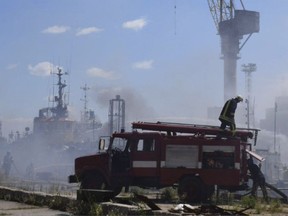 In this photo provided by the Odesa City Hall Press Office, firefighters put out a fire in the port after a Russian missiles attack in Odesa, Ukraine, Saturday, June 5, 2022. Russian missiles have struck Ukraine's Black Sea port of Odesa just hours after Moscow and Kyiv signed deals to allow grain exports to resume from there.