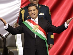 FILE - Mexico's incoming President Enrique Pena Nieto of the Institutional Revolution Party (PRI) wears the presidential sash after being sworn-in at his inauguration ceremony before Congress in Mexico City, Dec. 1, 2012. Mexico's anti-money laundering agency said on July 7, 2022 it has accused Peña Nieto of handling millions of dollars in possibly illegal funds.