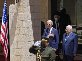 U.S. President Joe Biden and Palestinian President Mahmoud Abbas listen to the national anthem during a welcoming ceremony the West Bank town of Bethlehem, Friday, July 15, 2022.