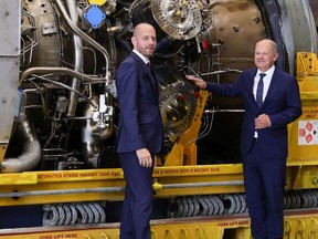 German Chancellor Olaf Scholz and Siemens Energy Chairman Christian Bruch examine the Siemens gas turbine for Russia's Nord Stream 1 gas pipeline at a Siemens Energy facility on August 3, 2022 in Muelheim an der Ruhr, Germany.