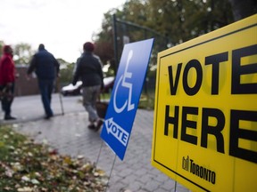 People enter a voting location on municipal election day in Toronto on October 22, 2018.