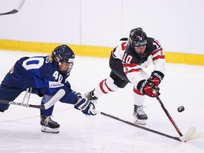 Noora Tulus of Finland battles Sarah Fillier of Canada during the IIHF World Championship Women's ice hockey match between Finland and Canada in Herning, Denmark, Thursday, Aug. 25, 2022.