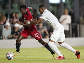 Toronto FC midfielder Richie Laryea (22) runs with the ball as Inter Miami defender Christian Makoun defends during the second half of an MLS soccer match, Wednesday, Oct. 20, 2021, in Fort Lauderdale, Fla. Toronto FC confirmed the re-acquisition of Laryea on loan from England's Nottingham Forrest on Friday.