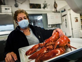 A employee weighs lobster in Shediac, N.B., on Wednesday, September, 22, 2021.