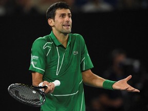 This file photo taken on February 2, 2020 shows Serbia's Novak Djokovic reacting after a point against Austria's Dominic Thiem during their men's singles final match on day fourteen of the Australian Open tennis tournament in Melbourne.