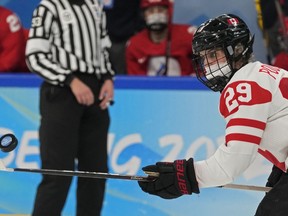 Canada's Marie-Philip Poulin reaches for the puck during a preliminary round women's hockey game against Russian Olympic Committee at the 2022 Winter Olympics, Monday, Feb. 7, 2022, in Beijing.&ampnbsp;Poulin scored twice and had an assist for Canada in a 9-0 win over Japan at the women's world hockey championship Sunday. THE&ampnbsp;CANADIAN PRESS/AP/Petr David Josek
