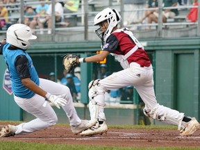 Canada catcher Alden Yu forces out Curacao's Jay-Dlynn Wiel (7) as he tried to score during the first inning of a baseball game at the Little League World Series tournament in South Williamsport, Pa., Tuesday, Aug. 23, 2022.