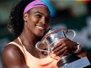 U.S. Serena Williams celebrates with the trophy following her victory over Czech Republic's Lucie Safarova after the women's singles final match of the Roland Garros 2015 French Tennis Open in Paris.