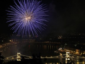 Fireworks burst over the "Chain Bridge," Hungary's oldest bridge, on the Danube River of Budapest downtown, late on August 20, 2011 at the end of the National day celebrations, marking the 1,011th anniversary of the Hungarian state established by its King St. Stephen.