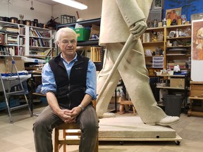 Edmonton sculptor Danek Mozdzenski sits with his creation, a sculpture of Sir Winston Churchill in plasticine form, ready for shpping to the foundry to be bronzed. The finished statue, donated by the Sir Winston Churchill Society of Calgary, will be erected on the grounds of the provincial government's McDougall Centre next spring. Photo courtesy of the Sir Winston Churchill Society of Calgary