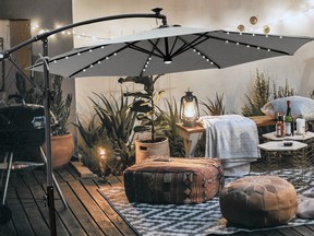A retractable umbrella can create cosy vibes on the patio in autumn. Fritts 120-inch Lighted Cantilever Umbrella can be purchased for $560, from wayfair.ca. Wayfair.ca