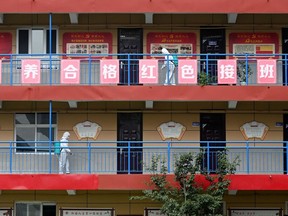 Staff members spray disinfectant along corridors at a school ahead of the new semester in Handan in China's northern Hebei province on August 29, 2022. The province is under lockdown again on Tuesday, after more COVID-19 outbreaks.