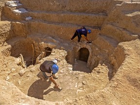 Staff of Israel's Antiquities Authority work at a newly-uncovered mansion dating back to the early Islamic period between the eighth and ninth centuries, in the Bedouin town of Rahat in Israel's southern Negev desert on August 23, 2022.
