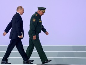 Russian President Vladimir Putin and Defence Minister Sergei Shoigu attend opening ceremones of Army-2022 at Patriot Congress and Exhibition Centre in the Moscow region, Russia August 15, 2022. REUTERS/Maxim Shemetov