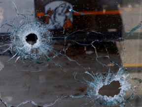 Bullet holes are seen in the windows of a pizzeria where unknown assailants killed four employees of a radio station, including an announcer when they were outside, according to local media, in Ciudad Juarez, Mexico August 12, 2022.