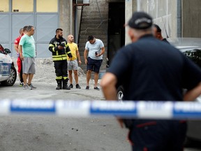 Rescue personnel talks to citizens at the crime scene of a mass shooting in Cetinje, Montenegro August 12, 2022.