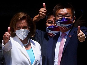U.S. Speaker of the House Nancy Pelosi gives the thumbs-up next to Legislative Yuan Vice-President Tsai Chi-chang as she leaves the Taiwanese parliament in Taipei on Aug. 3, 2022. Prime Minister Justin Trudeau recently said a group of Canadian parliamentarians who are planning to visit Taiwan should "reflect" on the "consequences" of their visit.
