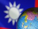 A globe is seen in front of Chinese and Taiwanese flags in this illustration, August 6, 2022. REUTERS/Dado Ruvic/Illustration