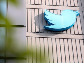 The Twitter logo is seen on a sign on the exterior of Twitter headquarters in San Francisco, California.