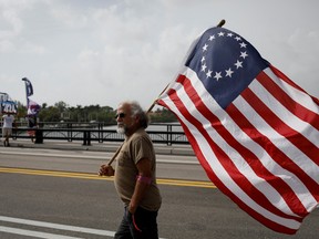 Trump supporters gather outside his Palm Beach, Florida estate after a raid by the FBI on August 9, 2022. REUTERS/Marco Bello