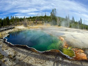 he Abyss Pool hot spring in Yellowstone National Park in Wyoming.