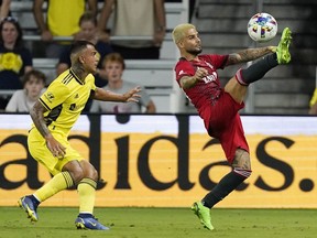 Toronto FC's Lorenzo Insigne, right, kicks the ball away from Nashville SC's Randall Leal, left, during the second half of an MLS soccer match Saturday, Aug. 6, 2022, in Nashville, Tenn.&ampnbsp;A medical issue involving Insigne's family promoted Toronto FC to delay its flight out of Nashville on the weekend so the Italian star could get more information on what was going on.THE CANADIAN PRESS/AP/Mark Humphrey