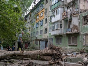 Local residents look at the damages after an early morning Russian forces' strike in Kostiantynivka, eastern Ukraine, amid the Russian invasion of Ukraine.
