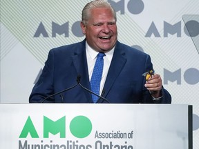 Ontario Premier Doug Ford jokes about swallowing a bee before speaking to the Association of Municipalities Ontario conference, Monday, August 15, 2022 in Ottawa.
