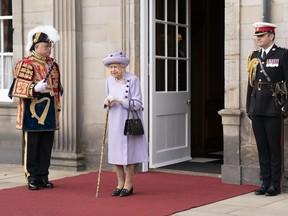 FILE - Queen Elizabeth II attends an armed forces act of loyalty parade in the gardens of the Palace of Holyroodhouse, Edinburgh, on June 28, 2022. Queen Elizabeth II will remain in Scotland, where she is taking her summer break, to receive Britain's outgoing Prime Minster Boris Johnson and his successor next week, Buckingham Palace officials said Wednesday, Aug. 31, 2022.