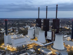 FILE - Steam leaves a cooling tower of the Lichterfelde gas-fired power plant in Berlin, Germany, March 30, 2022. German officials said Wednesday that the country is continuing to export electricity to neighboring France despite calling on citizens to save energy at home due to looming shortages.