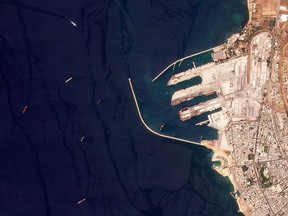 This satellite image from Planet Labs PBC shows the Russian-flagged cargo ship SV Konstantin, the red vessel the furtherest left, off the port in Tartus, Syria, Wednesday, Aug. 17, 2022. The Konstantin, that Ukraine alleges holds stolen grain from territory seized by Moscow amid the war there, appears to have reached the Syrian port of Tartus, satellite images analyzed Thursday by The Associated Press show.