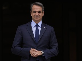 FILE - Greece's Prime Minister Kyriakos Mitsotakis stands outside Maximos Mansion in Athens, May 6, 2022. Mitsotakis insists he was unaware that the country's intelligence service had been bugging the mobile phone of an opposition politician for three months, and that had he known, he would not have allowed it. The comments came in a televised address to the nation by Mitsotakis, on Monday, Aug. 8.