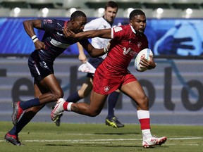United States' David Still attempts too tackle Canada's Josiah Morra during their Los Angeles rugby sevens series pool match at Dignity Health Sports Park in Carson, Calif., Saturday, Aug. 27, 2022.