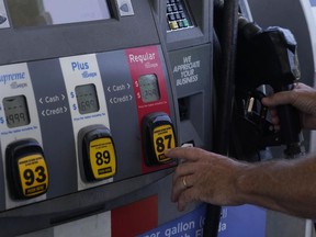 A customer pumps gas at an Exxon gas station, Tuesday, May 10, 2022, in Miami. Gasoline prices are sliding back toward the $4 mark for the first time in more than five months -- good news for consumers who are struggling with high prices for many other essentials.