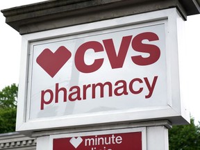 FILE - A CVS Pharmacy sign stands in Mount Lebanon, Pa., on Monday May 3, 2021. CVS Health said Tuesday, Aug. 2, 2022, that it thumped second-quarter expectations and hiked its full-year forecast as growing prescription claims and COVID-19 test kits sales helped balance a drop in vaccinations for the health care giant.