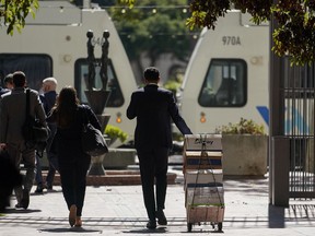 A stack of boxes is wheeled away by the team of attorneys representing the PGA Tour outside a federal courthouse in San Jose, Calif., Tuesday, Aug. 9, 2022. A federal judge has ruled that three golfers who joined Saudi-backed LIV Golf will not be able to compete in the PGA Tour's postseason.