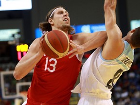 Canada's Kelly Olynyk pushes into Argentina's Nicolás Laprovittola during first half action of the FIBA Basketball World Cup 2023 Americas qualifiers in Victoria, B.C., on Thursday, August 25, 2022.