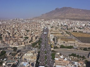 FILE - Houthi supporters attend a rally marking the seventh anniversary of the Saudi-led coalition's intervention in Yemen's war, in Sanaa, Yemen, March 26, 2022. The United Nations says Yemen's warring parties agreed Tuesday, Aug. 2, to renew an existing truce for another two months after international concerted efforts. The U.N.'s envoy to Yemen Hans Grundberg said in a statement that Yemen's internationally recognized government and the country's Houthi rebels agreed to extend the truce.