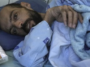 FILE - Khalil Awawdeh, a Palestinian who has been on a hunger strike for several months protesting being jailed without charge or trial under what Israel refers to as administrative detention, lies in bed at Asaf Harofeh Hospital in Be'er Ya'akov, Israel, Wednesday, Aug. 24, 2022. Awawdeh, a Palestinian detainee held without charge or trial by Israel will suspend his nearly six-month hunger strike after receiving a "written agreement" that he will be released in October, Palestinian officials said Wednesday, Aug. 31.