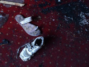 Abandoned shoes remain at the site of a fire inside the Abu Sefein Coptic church that killed at least 40 people and injured some 14 others, in the densely populated neighborhood of Imbaba, Cairo Egypt, Sunday, Aug. 14, 2022.