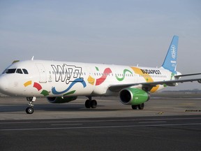 FILE - An aircraft of the low-cost of Wizz Air airlines painted in the colours of the logo of host city candidate Budapest for the 2024 Olympic and Paralympic Games is displayed in Liszt Ferenc International Airport in Budapest, Hungary, Nov. 24, 2016. Hungary's government has ordered an investigation of domestic low-cost carrier Wizz Air over what it calls possible breaches of consumer protection laws, the second such investigation it has launched against an airline since June 2022.
