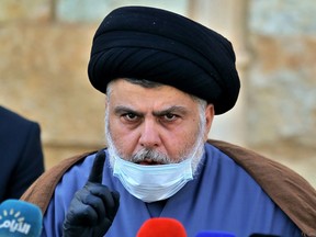 FILE - Influential Shiite cleric Muqtada al-Sadr speaks during a press conference in Najaf, Iraq, Feb. 10, 2021. Al-Sadr who's followers have been staging a sit-in outside Iraq's parliament announced his resignation from politics and the closure of his party's offices on Monday, Aug. 29, 2022. It is an unexpected plot twist more than four weeks after his supporters stormed the parliament building to prevent his Iran-backed rivals from forming a government.