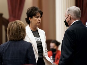 State Sen. Connie Leya, D-Chino, center, talks with fellow Democratic state Senators, Maria Elena Durazo, of Los Angeles, left and Richard Roth, of Riverside, at the Capitol in Sacramento, Calif., Wednesday, Aug. 31, 2022. On Wednesday, California lawmakers, approved Leyva's bill to make vasectomies cheaper for men.