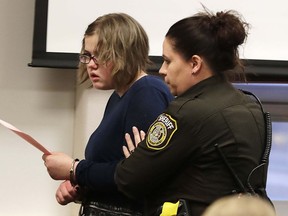 FILE- Morgan Geyser is escorted out of the courtroom following her sentencing on Feb. 1, 2018, in Waukesha, Wis. Geyser, one of two Wisconsin women who were sent to a state mental health facility after a 2014 stabbing attack on a sixth-grade classmate that they claimed was to appease the horror character Slender Man has withdrawn her petition for release. In June, Geyser, now 20, asked Waukesha County Judge Michael Bohren to order her release as he did last year for her co-defendant, Anissa Weier, who spent nearly four years at a mental health facility in Oshkosh.
