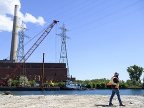 Emergency workers monitor the site of a collision between a barge carrying a crane and power lines are photographed in Toronto, on Thursday, August 11, 2022.