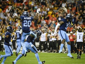 Toronto Argonauts defensive back Jamal Peters (3) celebrates after scoring a touchdown by intercepting a pass by Hamilton Tiger-Cats quarterback Dane Evans (9), during second half CFL football action in Toronto, on Friday, August 26, 2022. Peters, Saskatchewan receiver Kian Schaffer-Baker and Calgary receiver Malik Henry have been named the CFL's top performers for Week 12.THE CANADIAN PRESS/Christopher Katsarov