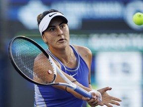 Bianca Andreescu, of Canada, returns a ball to Daria Kasatkina, of Russia, during tennis action at the National Bank Open in Toronto Tuesday, Aug. 9, 2022.