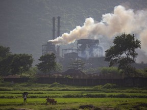 FILE- Smoke rises from a coal-powered steel plant at Hehal village near Ranchi, India, in eastern state of Jharkhand, Sept. 26, 2021. Nine months after India announced its target of "net zero" emissions by 2070 at the United Nations climate conference in Glasgow, the country's federal cabinet finally approved it on Wednesday, Aug. 3, 2022.