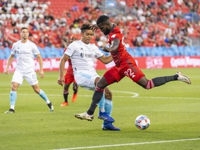 Back home on loan from Nottingham Forest, Richie Laryea gives Toronto FC the kind of threat from fullback it used to have. Laryea battles with New England Revolution's Brandon Bye during the first half of MLS soccer action in Toronto, Saturday August 14, 2021.